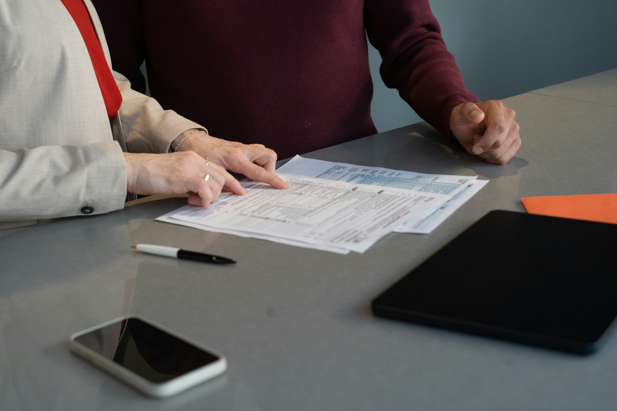 Hands reviewing detailed business documentation