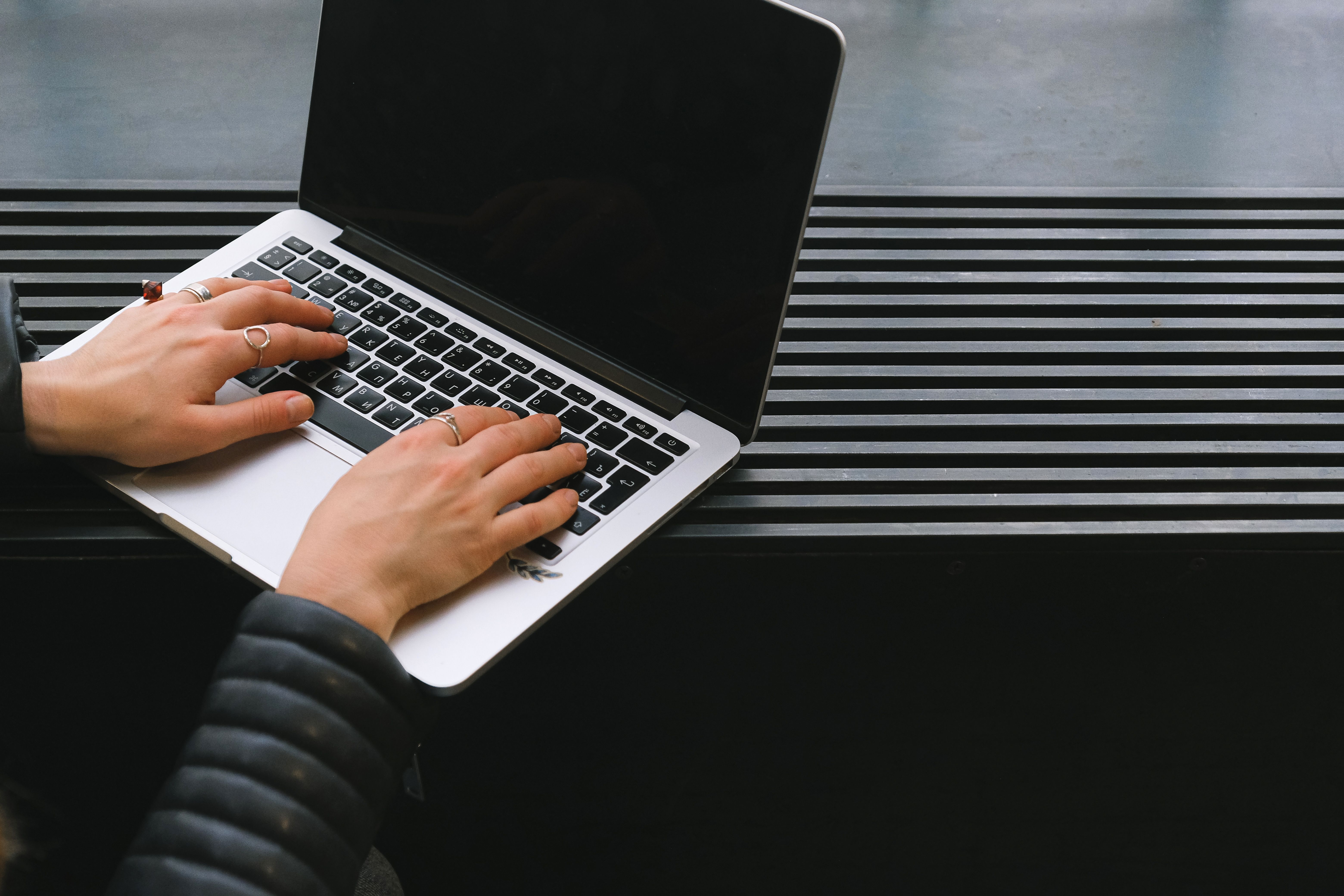 Hands working on a laptop in a professional workspace